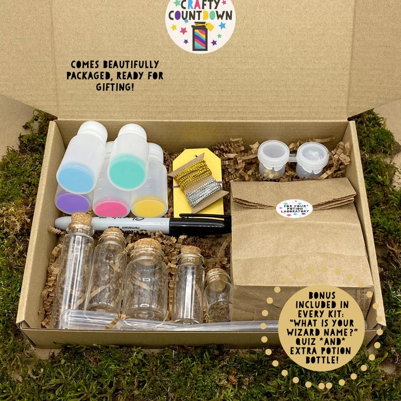 May include: An open cardboard box filled with potion-making supplies. The kit includes small glass bottles with corks, plastic bottles with colorful lids, a marker, and a brown paper bag. Text on the box reads "Crafty Countdown" and "Comes beautifully packaged, ready for gifting!"