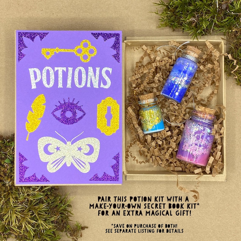 May include: A purple glittery book with the word "POTIONS" and various gold and white illustrations. Next to the book is a wooden box with three small glass bottles filled with colorful glitter and cork stoppers. The text on the image says "PAIR THIS POTION KIT WITH A MAKE-YOUR-OWN SECRET BOOK KIT* FOR AN EXTRA MAGICAL GIFT!"