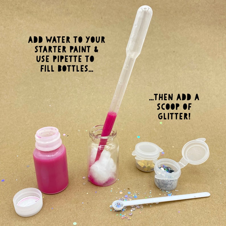 May include: A craft supplies image shows a pink paint bottle, a pipette, and small containers of glitter. Text reads: "ADD WATER TO YOUR STARTER PAINT & USE PIPETTE TO FILL BOTTLES...THEN ADD A SCOOP OF GLITTER!" The image is on a light brown surface.