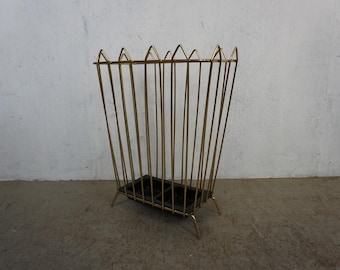 Iconic umbrella stand made of shiny gold brass