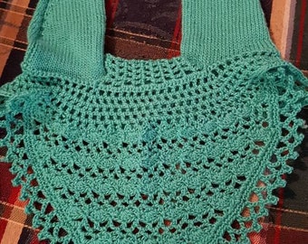 May include: A teal crocheted horse fly bonnet with a delicate lace pattern. The bonnet is made of soft yarn and has a simple design.