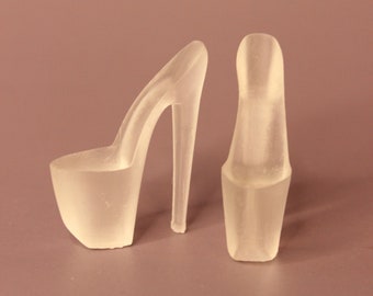 May include: A pair of clear plastic high-heeled shoes with a platform sole.