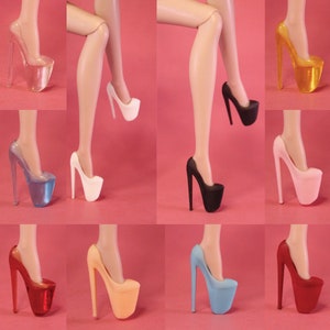 May include: A set of ten high-heeled platform shoes in various colours, including clear, white, black, blue, pink, and red. The shoes have a thick platform and a tall stiletto heel.