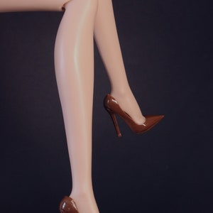 May include: A pair of brown high-heeled shoes with pointed toes.