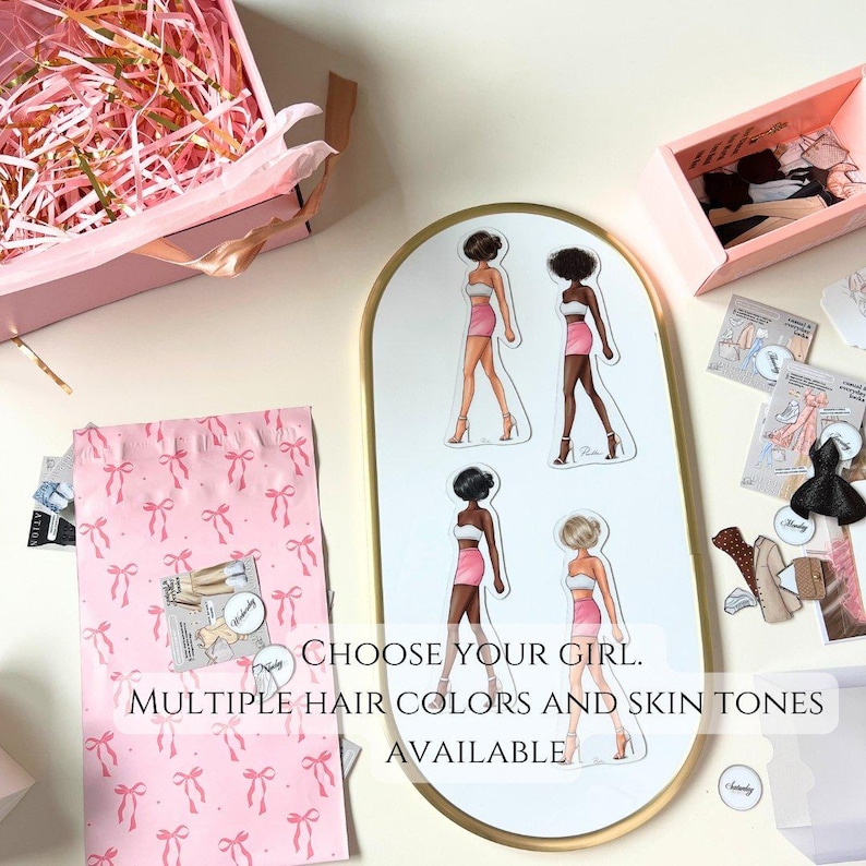 May include: A set of paper dolls with different hair and skin tones. The dolls are wearing pink skirts and white tops. The text on the image reads "Choose your girl. Multiple hair colors and skin tones available."