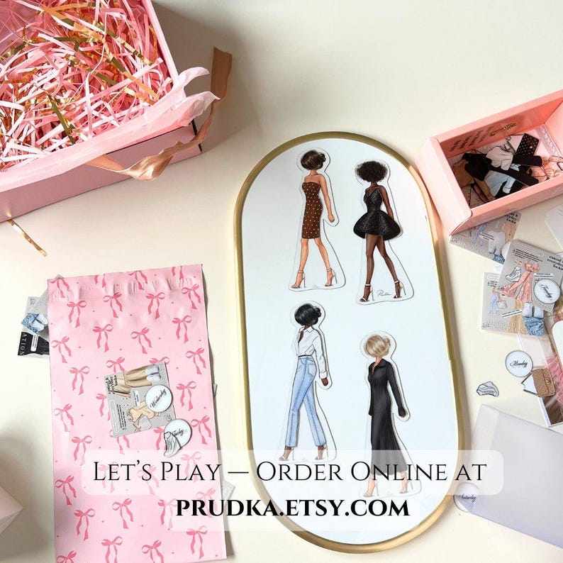 May include: A set of four paper doll cutouts featuring women in different outfits. The dolls are on a white background with a gold oval frame. The text "Let's Play - Order Online At PRUDKA.ETSY.COM" is at the bottom of the frame.