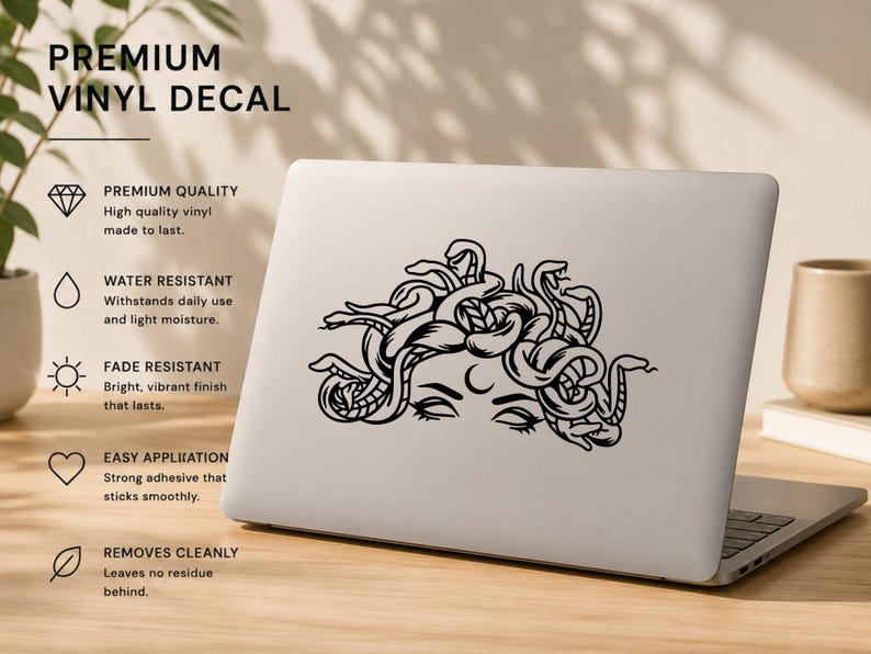 May include: Black vinyl decal of Medusa on a laptop. The decal is water-resistant, fade-resistant, and has a strong adhesive. Text on the image reads "PREMIUM VINYL DECAL".