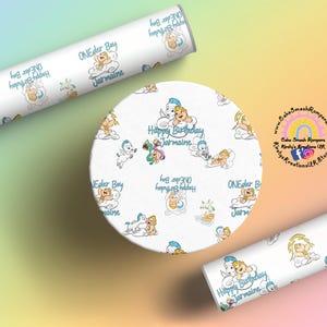 May include: White wrapping paper and a round cake topper with a repeating pattern of cartoon babies on clouds. The text "ONEder Boy Jarmaine" and "Happy Birthday Jarmaine" are visible. The background is a gradient of pastel colors.