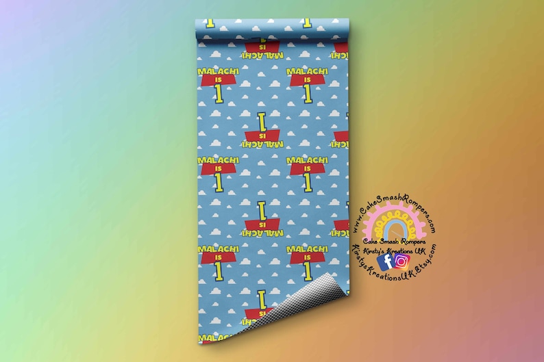 May include: A blue and white patterned wrapping paper with a red and yellow sign that says "Malachi is 1". The sign is repeated throughout the pattern.