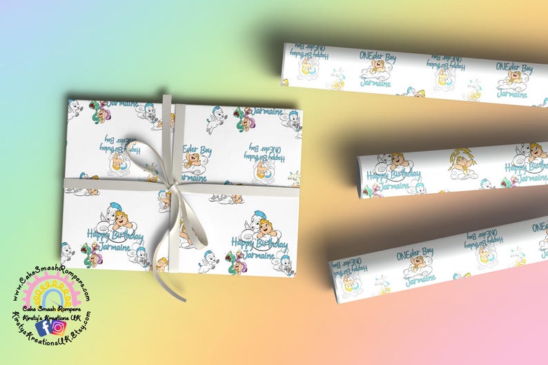 May include: White wrapping paper with a repeating pattern of cartoon characters, clouds, and the text "Happy Birthday Jermaine" and "ONEder Boy". A gift is wrapped with a white ribbon. Rolls of matching paper are also visible.