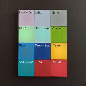 May include: A color chart with 12 painted wooden squares, each labeled with a color name. The colors are lavender, lilac, gray, mint, turquoise, green, blue, dark blue, yellow, sea wave, red, and coral.