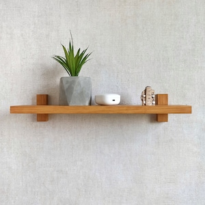 Wall shelf hand made of natural wood . Minimalistic floating shelf