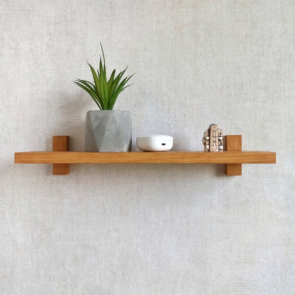 Wall shelf hand made of natural wood . Minimalistic floating shelf