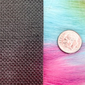 May include: A close-up image features a textured, dark brown woven material next to a vibrant, multicolored faux fur in shades of pink, blue, and green. A U.S. dime is placed on the fur for scale, showing the texture and color variations.