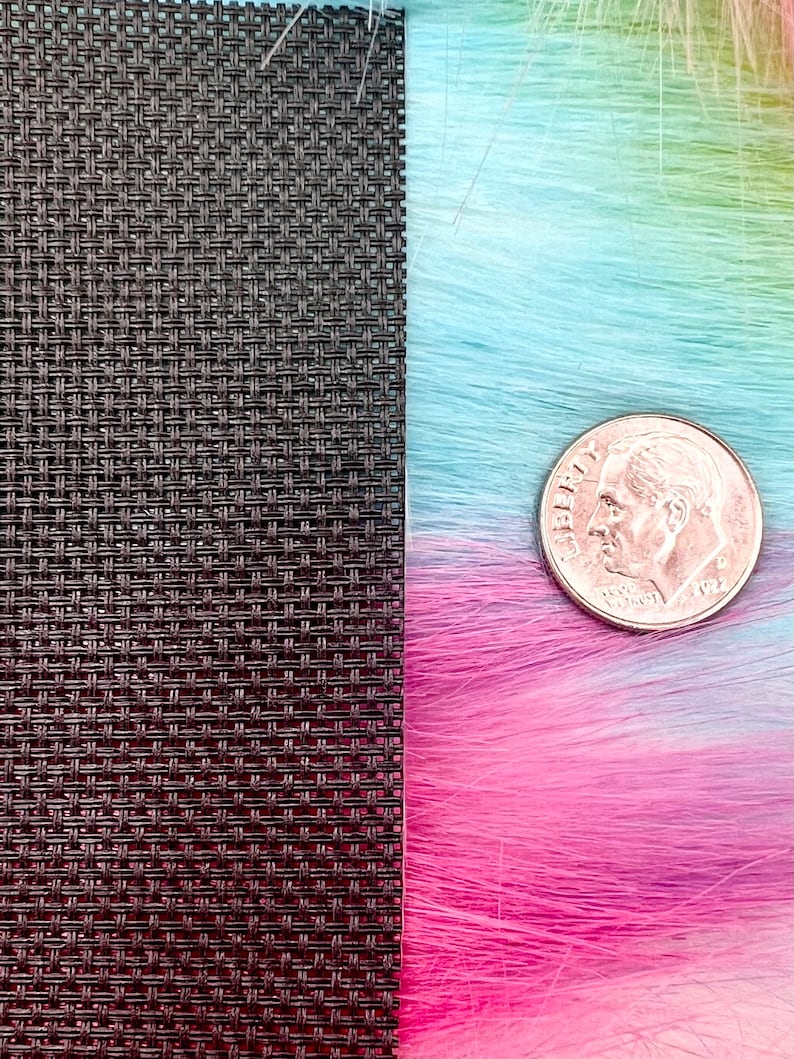 May include: A close-up image features a textured, dark brown woven material next to a vibrant, multicolored faux fur in shades of pink, blue, and green. A U.S. dime is placed on the fur for scale, showing the texture and color variations.