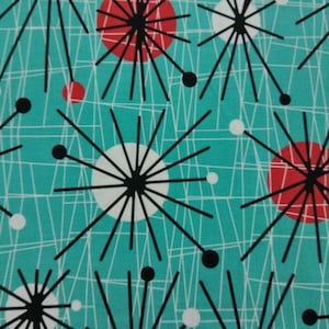 May include: A teal fabric with a mid-century modern design. The pattern features red and white circles, black starbursts, and white intersecting lines. The design is repeated across the fabric.