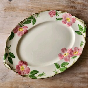 May include: A set of three ceramic mugs with a speckled, matte finish. Each mug features a different color: light blue, cream, and gray. The mugs have a simple, modern design with a rounded shape and a comfortable handle.