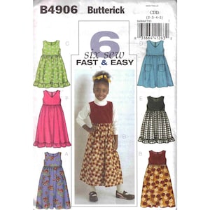 May include: Butterick B4906 sewing pattern for girls' dresses. The pattern features six dress designs, with options for different fabrics and styles. The text "six sew FAST & EASY" is visible on the pattern.