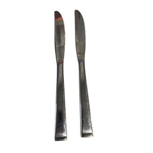 May include: Two silver butter knives with a polished finish.