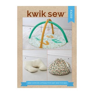 May include: A baby support, interactive mat, and toy bag sewing pattern. The mat has a green and yellow arch with hanging toys. The mat is round with the word "LOVE" on it. The pattern also includes a white pillow and a drawstring bag.