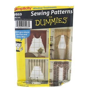 May include: A Simplicity Window Treatments Sewing Patterns for Dummies envelope, number 9869. The yellow and black packaging features illustrations of four different curtain styles, including swags and valances, with the text Stitch up a storm.