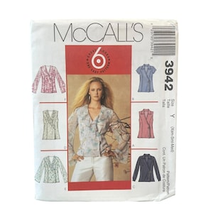 May include: A McCall's 3942 sewing pattern envelope for a wrap-style blouse with various sleeve and ruffle options. The front displays illustrations of six different blouse variations, a central photograph of a model, and the text 3942 Size Y.
