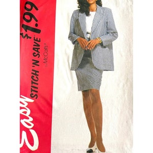 May include: A black and white gingham blazer and skirt set. The blazer has a notched collar and long sleeves. The skirt is a pencil skirt that hits just above the knee. The model is wearing white heels. The text on the image reads "Easy Stitch 'N Save £1.99 by McCall's".