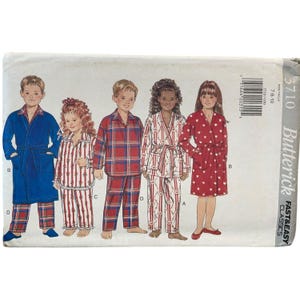 May include: A Butterick Classics sewing pattern for children's pajamas and robes. The pattern features illustrations of children wearing various pajama sets and robes in red, blue, and white. The pattern size is 7-8-10.