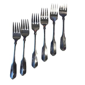 May include: Set of six silver salad forks with ornate handles.