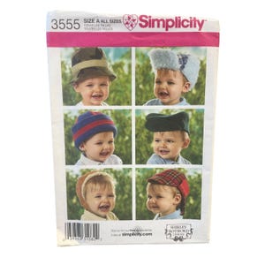 May include: Simplicity sewing pattern 3555 for children's hats. The package features six images of infants wearing various styles including a camouflage bucket hat, a blue faux fur trapper hat, a striped beanie, a dark green cap, and plaid hats.
