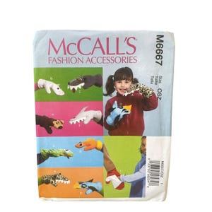 May include: McCall's M6667 Fashion Accessories sewing pattern envelope featuring illustrations of various animal-themed hand puppets. The package displays multiple colorful puppet designs including a shark, leopard, and other creatures, with text indicating size OSZ.