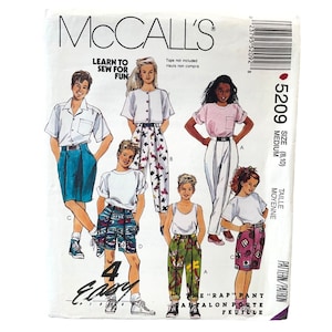 May include: A McCall's sewing pattern package featuring illustrations of children's clothing designs. The package includes the text "LEARN TO SEW FOR FUN" and the pattern number 5209. The designs include shorts, pants, and tops.