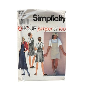 May include: A Simplicity 9503 sewing pattern envelope for a 2 hour jumper or top. The front shows illustrations of three variations of the garment: a long dark blue jumper, a plaid jumper, and a short beige jumper worn over a white t-shirt.