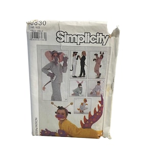 May include: Simplicity sewing pattern number 8830, one size, for a child's costume. The pattern includes instructions for making an elephant, bunny, dog, and a sea creature costume. The pattern cover features illustrations of children wearing the costumes.