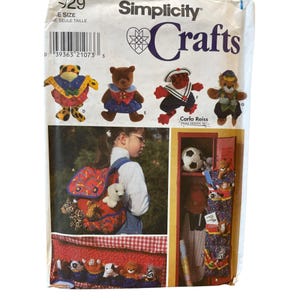 May include: Simplicity Crafts sewing pattern featuring stuffed animal designs. The pattern includes instructions for making various plush toys, including bears and other creatures. The image also shows a backpack and a locker organizer.
