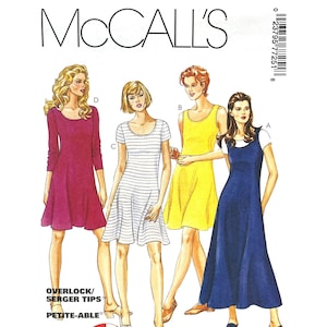 May include: McCall's sewing pattern featuring four dress designs. The dresses include a long-sleeved magenta dress, a white and gray striped dress, a yellow dress, and a navy blue dress. The pattern includes overlock and serger tips.