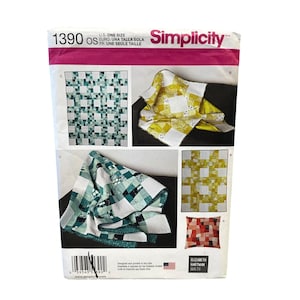 May include: A Simplicity sewing pattern envelope featuring quilt designs. The envelope displays images of finished quilts in various color schemes, including green, yellow, and red. The pattern number is 1390 OS, and the brand name "Simplicity" is visible.