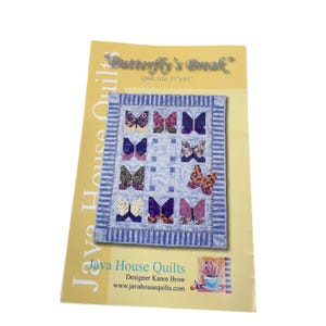 May include: A quilt pattern titled "Butterfly's Break" by Java House Quilts. The pattern features a quilt design with butterfly appliqués in various colors. The quilt size is 53" x 65". The pattern also includes the designer's name and website.