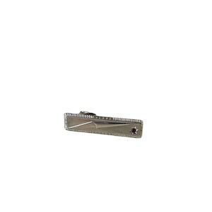 May include: Silver tie bar with a red stone in the shape of a star.