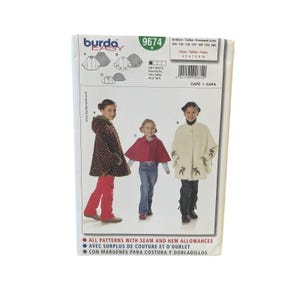 May include: A sewing pattern package labeled "burda easy 9674" featuring illustrations of capes. The package includes images of children wearing capes in various styles and colors. Text on the package includes size information and instructions.