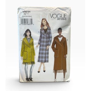 May include: Vogue Patterns V9231 sewing pattern envelope featuring illustrations of three coat styles. Style A is a yellow fringed coat, Style C is a blue plaid long coat, and Style B is a brown fringed coat. The envelope includes size Y (Xsm-Sml-Med).
