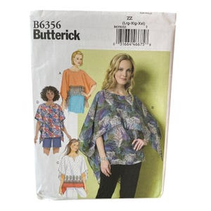 May include: A Butterick sewing pattern, B6356, featuring illustrations of women's tops. The pattern includes various styles, such as a fringed poncho, a floral print top, and a white top with a decorative border. The size range is Lrg-Xlg-Xxl.