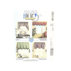 May include: A McCall's Home Decor sewing pattern, M5148, showing four valance designs. The pattern includes an arch valance, a petite balloon valance, a gathered balloon valance, and a shirred balloon valance. The package is white with images of the valances.