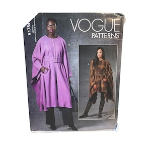 May include: Vogue Patterns sewing pattern featuring a woman in a purple cape coat and another in a plaid cape. The pattern includes sizes 22, XLG, and XXL. The Vogue logo is at the top.