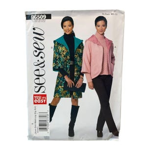 May include: See & Sew pattern B6509 features two jacket styles. Style B is a long, hooded coat with a teal lining and a dark, multi-colored abstract print. Style A is a shorter, hooded pink jacket with a matching pink lining, worn over a sweater.