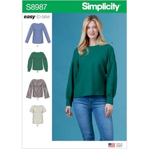 May include: Simplicity sewing pattern S8987, featuring four different top designs. The image shows a woman wearing a green long-sleeved top with a round neckline and a relaxed fit. The pattern includes options for various sleeve styles and fabrics. The text "easy-to-sew" is visible.