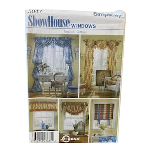 May include: A Simplicity ShowHouse Windows English Cottage sewing pattern envelope featuring illustrations of various window treatments, including blue and white floral curtains, yellow valances, and a plaid Roman shade with a barcode at the bottom.