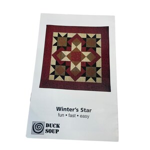 May include: A quilt pattern titled "Winter's Star" with a starburst design in shades of red, brown, and beige. The pattern is on a white background with the Duck Soup logo. The text reads "fun • fast • easy."