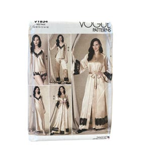May include: Vogue Patterns V1834 sewing pattern envelope featuring illustrations of champagne-colored loungewear sets with black lace trim. The designs include a camisole, shorts, trousers, a long slip dress, and a robe. Size range B5 8-10-12-14-16.