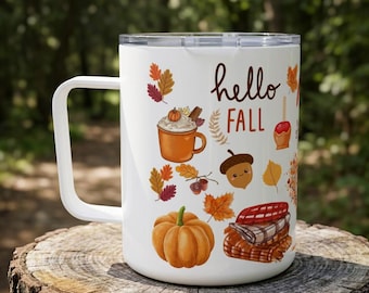 May include: A white travel mug with a clear lid and a handle, featuring a colorful autumn-themed graphic print. The design includes the text "hello FALL" surrounded by illustrations of a pumpkin, an acorn, a mug of cocoa, and fall leaves.